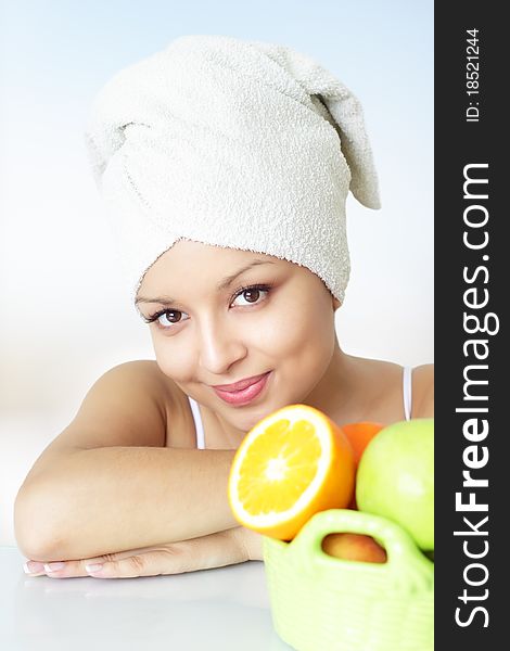 Girl with fruits on a light background