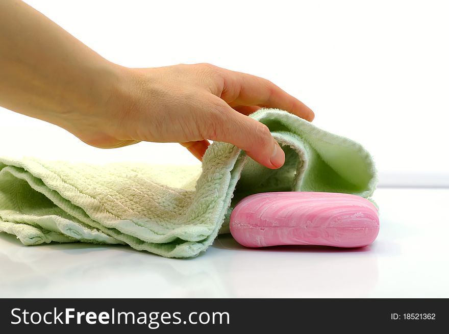 Female hand takes towel and soap by closeup