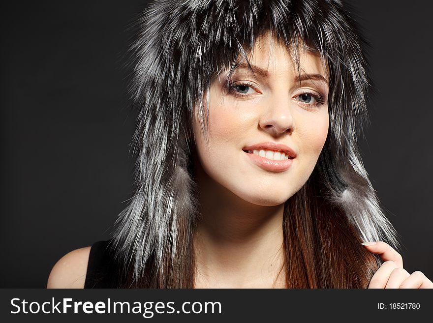 Portrait of young female in fur hat