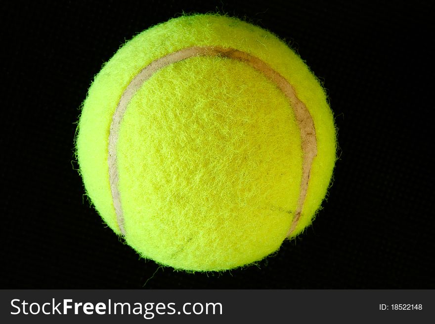 One green tennis ball isolated on black background. One green tennis ball isolated on black background.