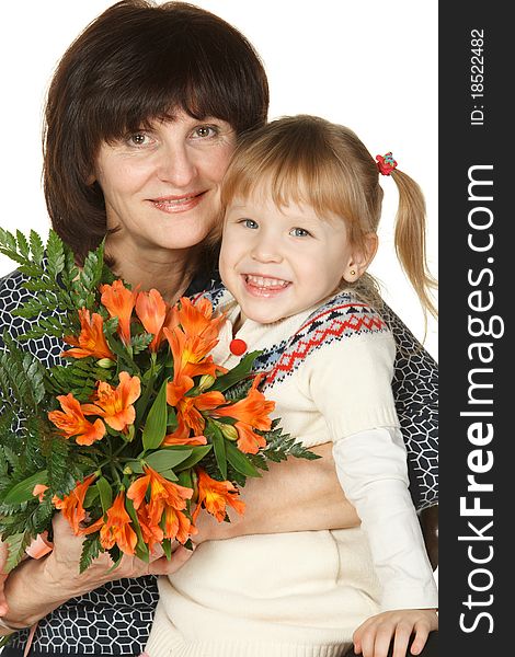 Grandmother and granddaughter with bunch of flower