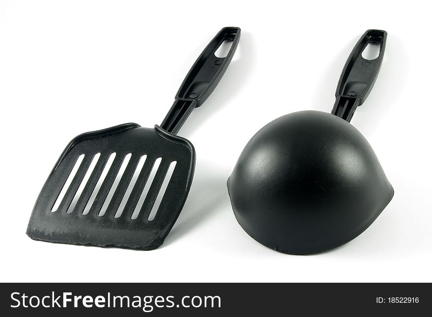 Two kitchen tools over the white surface