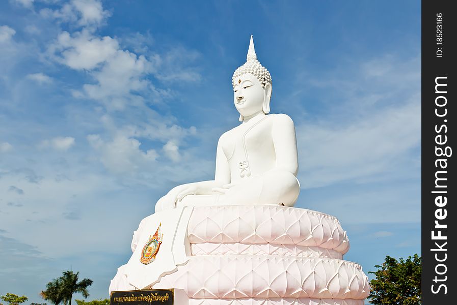 White Buddha statue with blue sky.