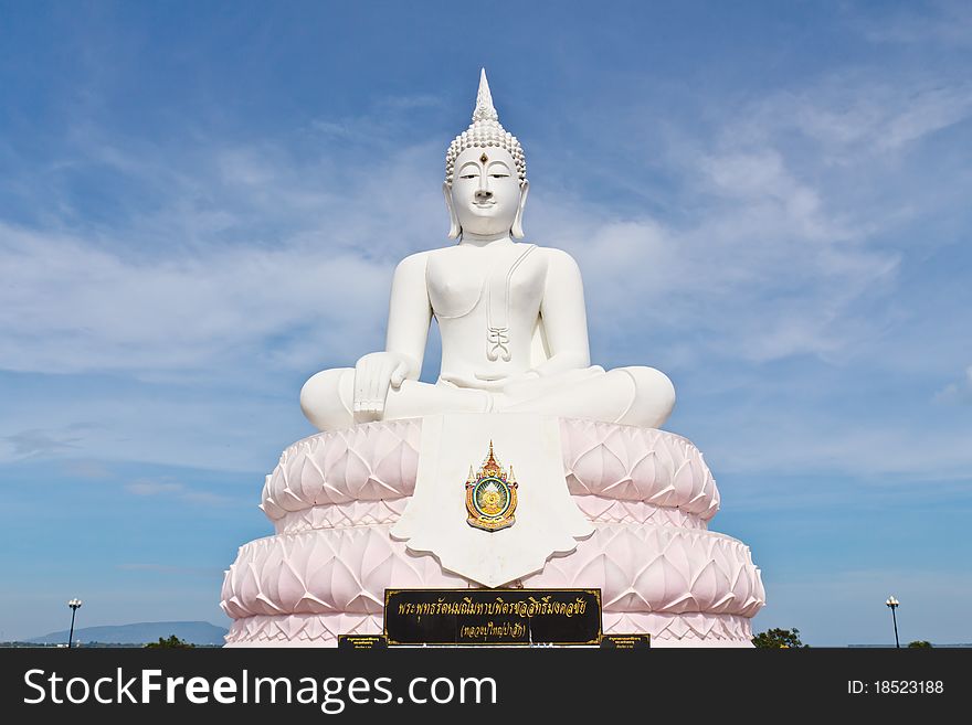 White image Buddha statue with blue sky.