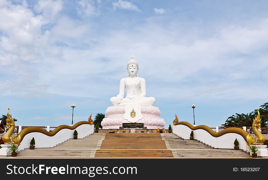 White Buddha statue with blue sky.