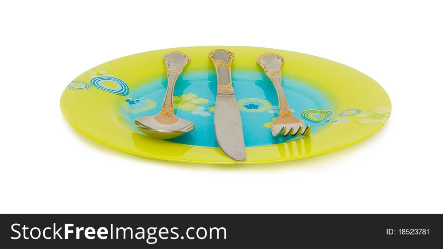 Flat dish, spoon, knife, fork on a white background