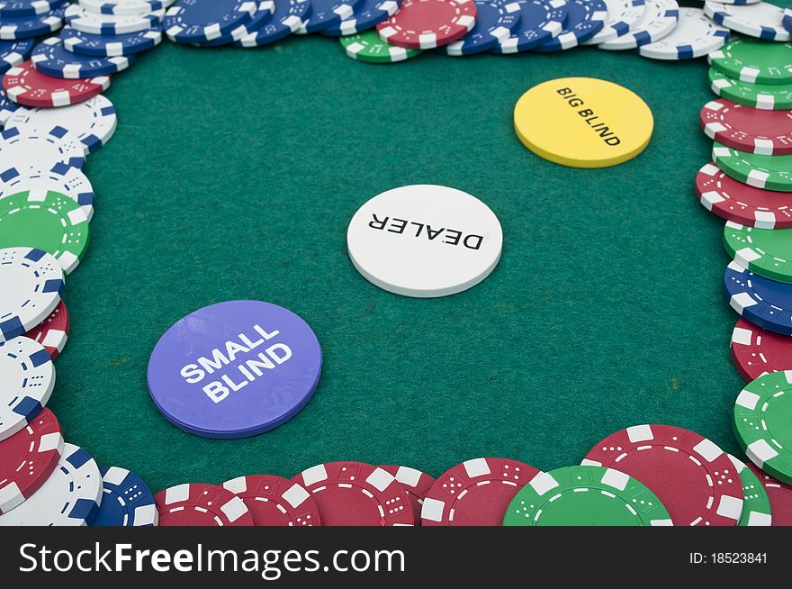 Many poker chips on the green table