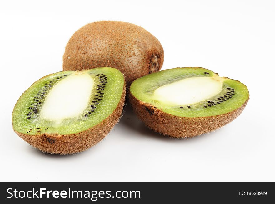 One kiwi and two half part on a white background. One kiwi and two half part on a white background