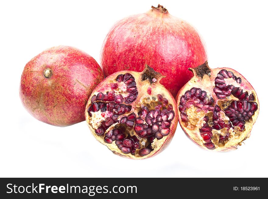 Three ripe and red pomegranates on a white background