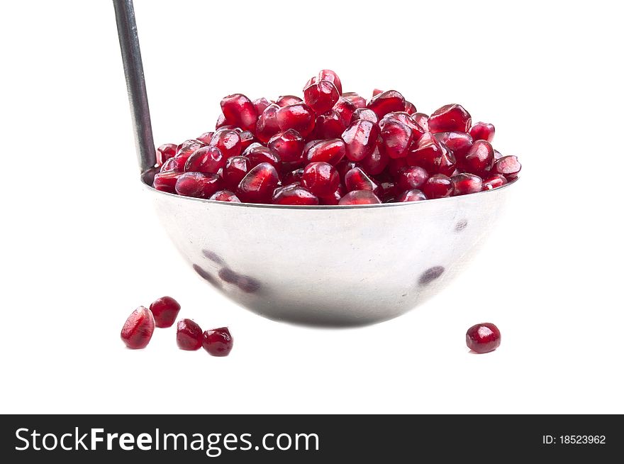 Many seeds with pomegranate on a white background