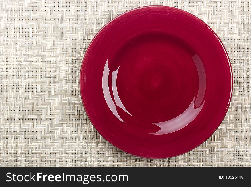 Round ceramic dish on a background mat for the second course. Round ceramic dish on a background mat for the second course.
