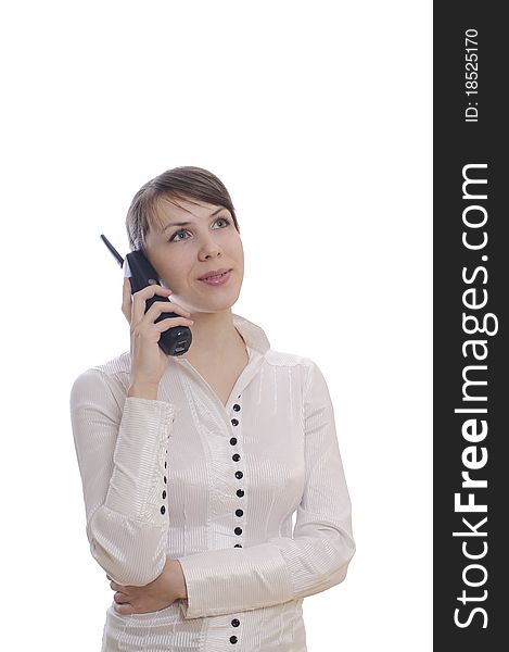 Isolated young business woman with a telephone