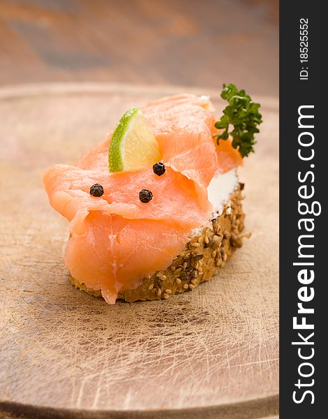 Photo of delicious crispy cereals bread with smoked salmon. Photo of delicious crispy cereals bread with smoked salmon