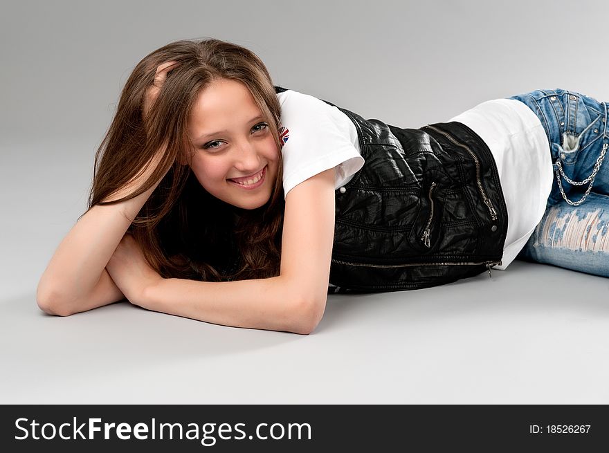 Young happy woman lying on the floor. Young happy woman lying on the floor