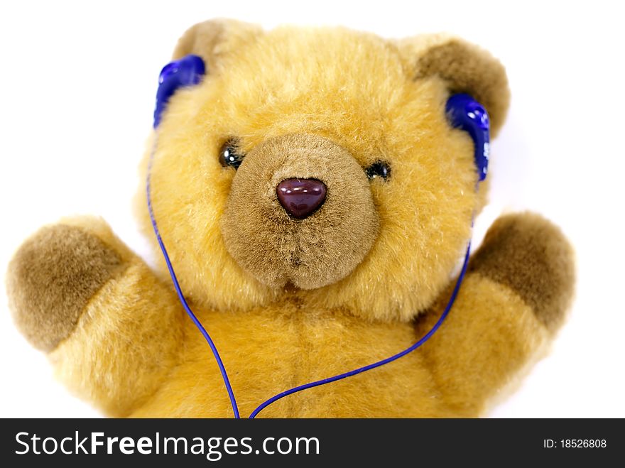 Teddy bear with headphones on his head.