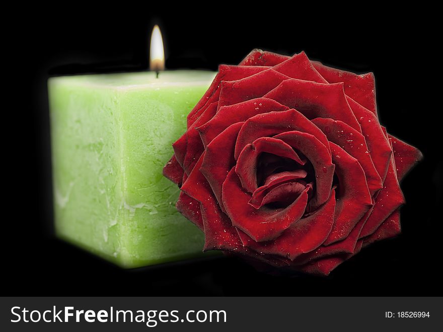 A green candle on a black background