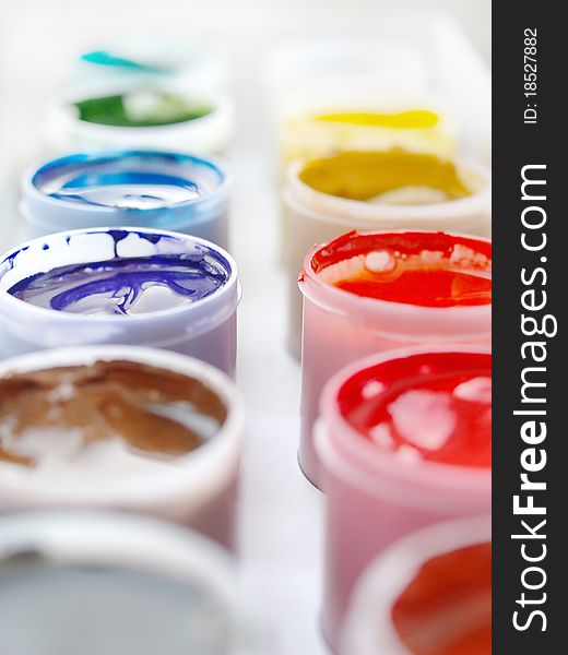 Gouache paints in plastic buckets