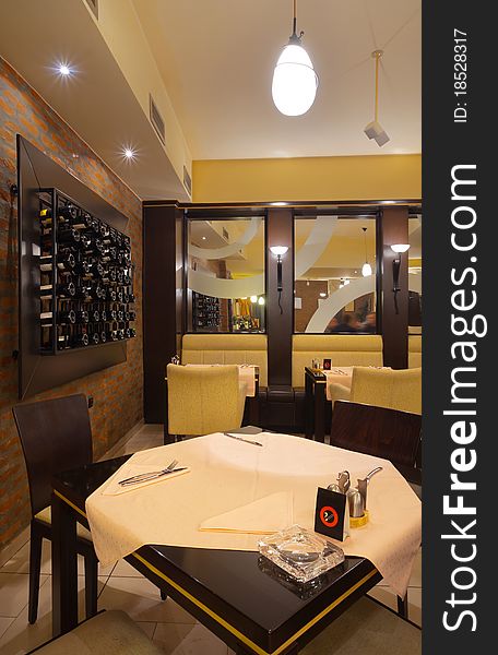 Tables, chairs, brick wall and lighting equipment of a restaurant. Tables, chairs, brick wall and lighting equipment of a restaurant.