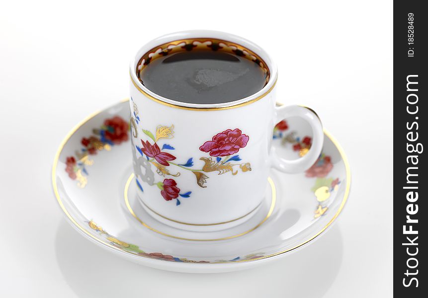 A cup of coffee in a traditional porcelain set. A cup of coffee in a traditional porcelain set