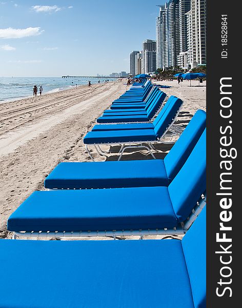 Blue lounge chairs on a resort beach. Blue lounge chairs on a resort beach.