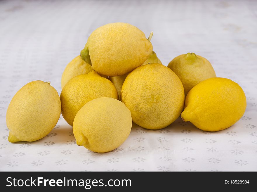 Close view of a bunch of lemons on top of a table. Close view of a bunch of lemons on top of a table.