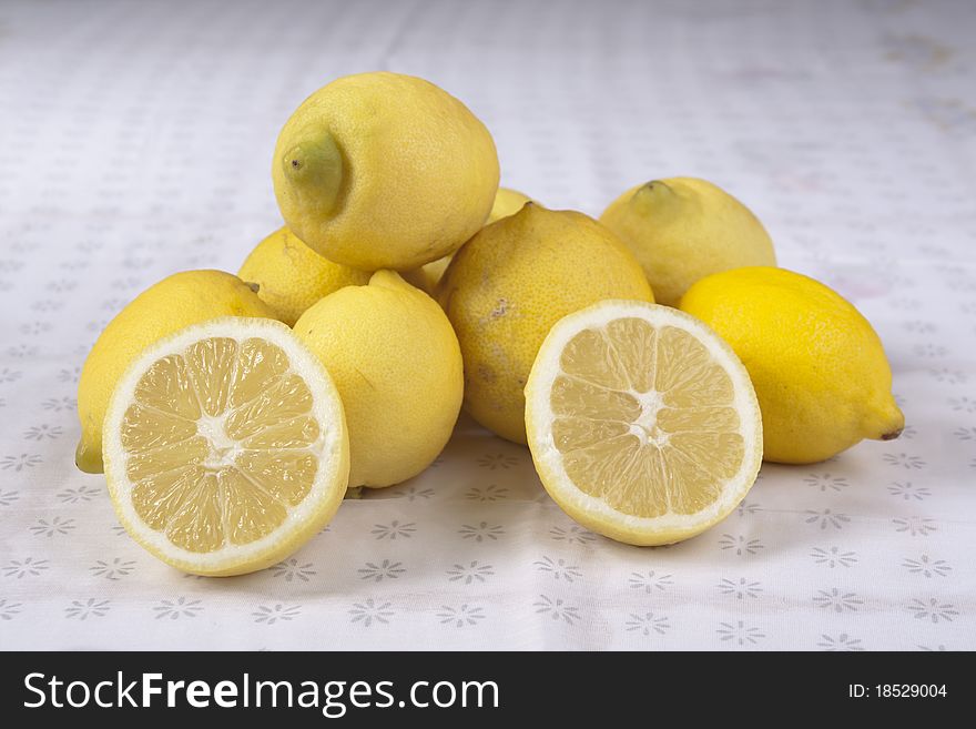 Close view of a bunch of lemons on top of a table. Close view of a bunch of lemons on top of a table.