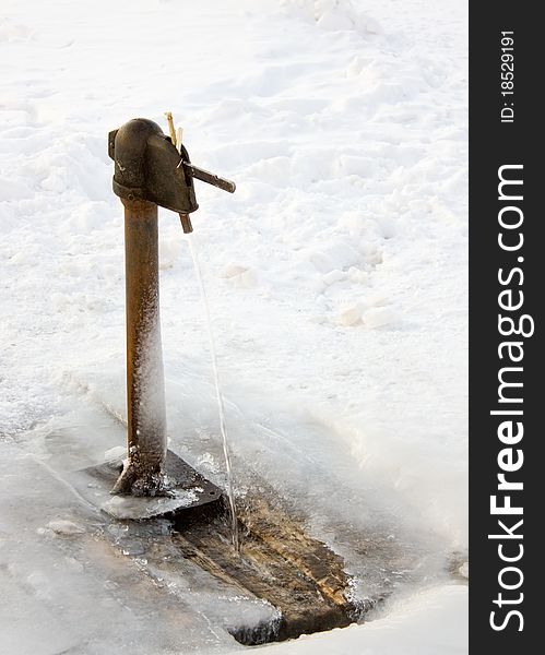 Pipe column in the winter in the ice.