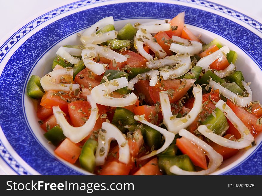 Detail view of a freshmade mediterranean salad isolated on a white background. Detail view of a freshmade mediterranean salad isolated on a white background.