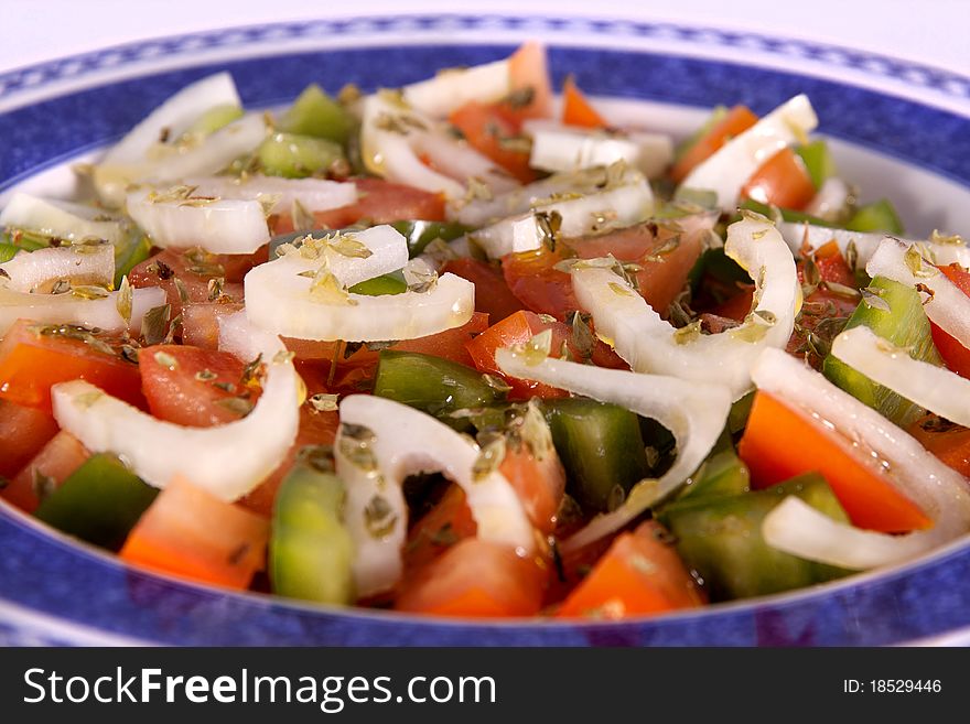 Detail view of a freshmade mediterranean salad isolated on a white background. Detail view of a freshmade mediterranean salad isolated on a white background.