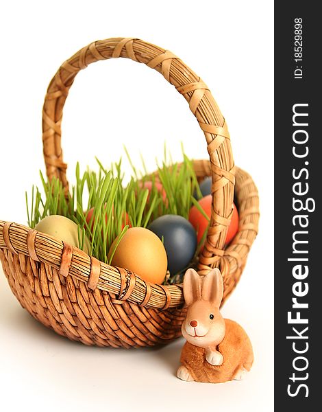 Basket with colored eggs on white. Basket with colored eggs on white