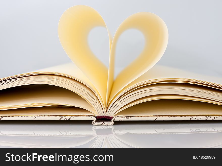 Heart shape with soft yellow pages of book. Heart shape with soft yellow pages of book