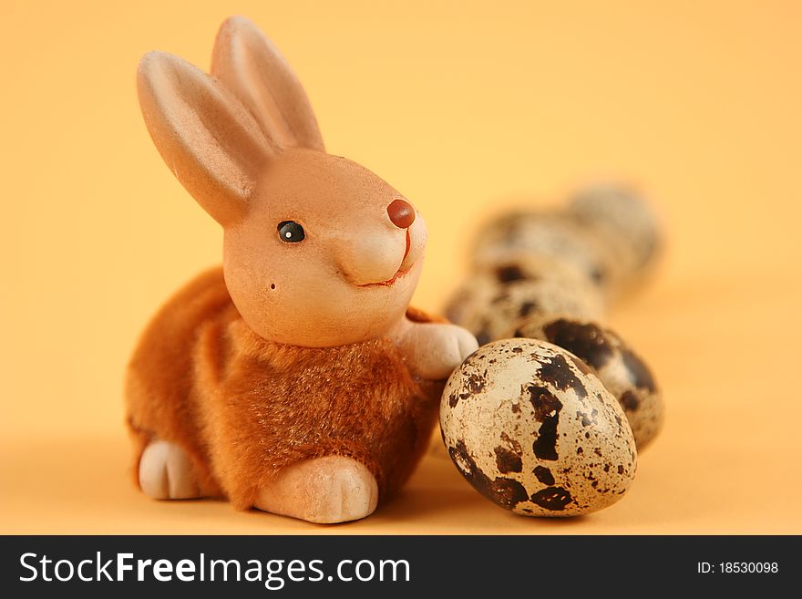 Easter bunny with colored eggs on yellow background. Easter bunny with colored eggs on yellow background