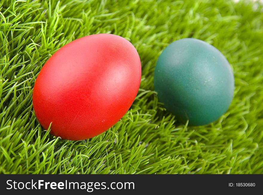 Colorful Easter eggs on green grass