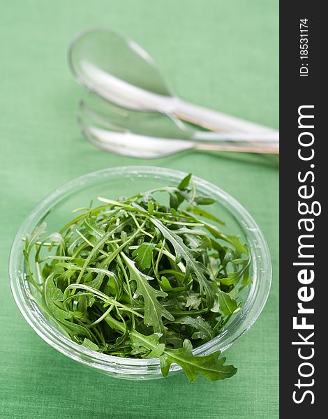 Green rucola fresh salad in glass bowl