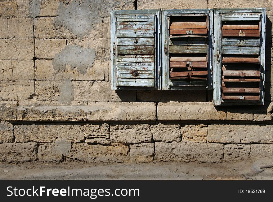 Old posting boxes on rough brick wall