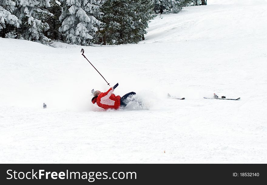 Falling skier in snow-covered mountains