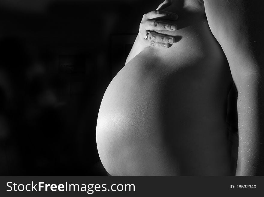 8 month pregnant lady shot on a black background. 8 month pregnant lady shot on a black background