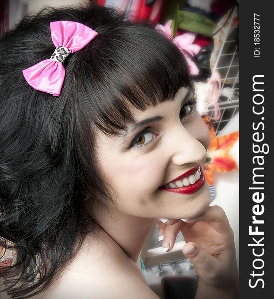 Adorable pinup model wearing pink hair bow