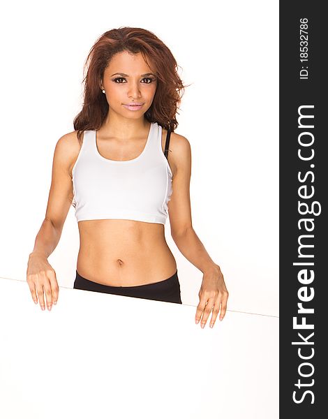 Cute young fitness woman holding a white board