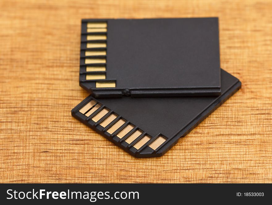 Two black memory cards on wooden table. Two black memory cards on wooden table