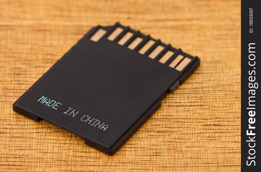 Black memory card on wooden table
