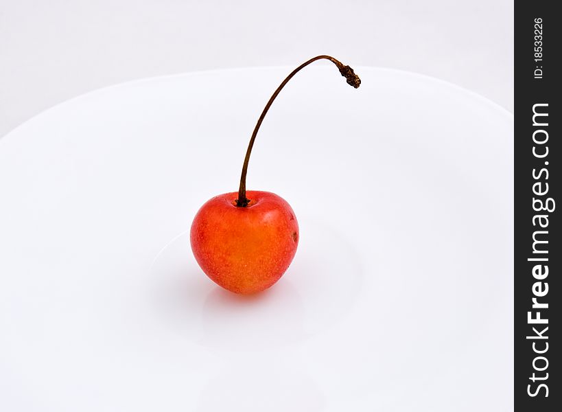 Sweet cherries.One cherries on white plate