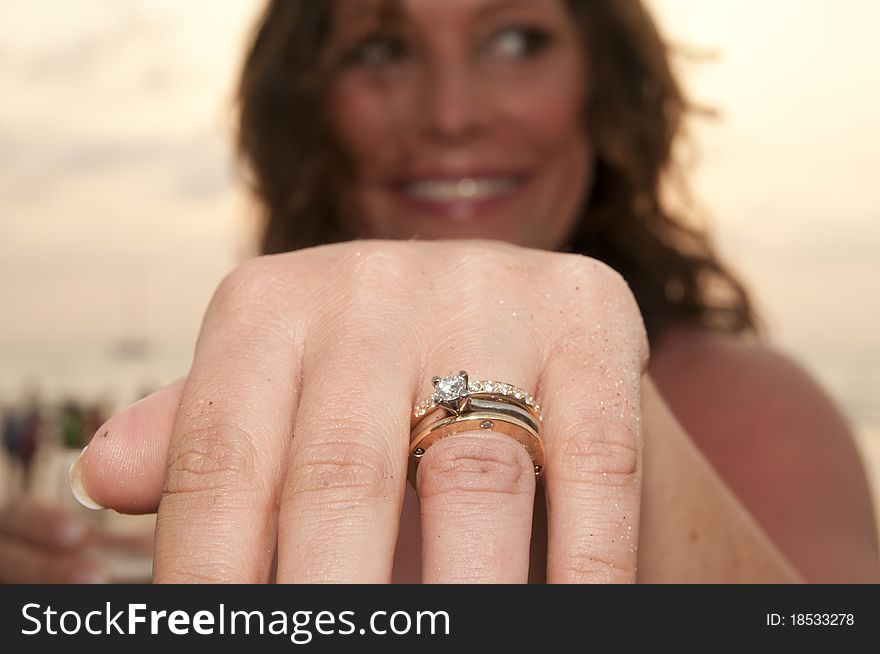 Beach wedding with bride,showing off ring