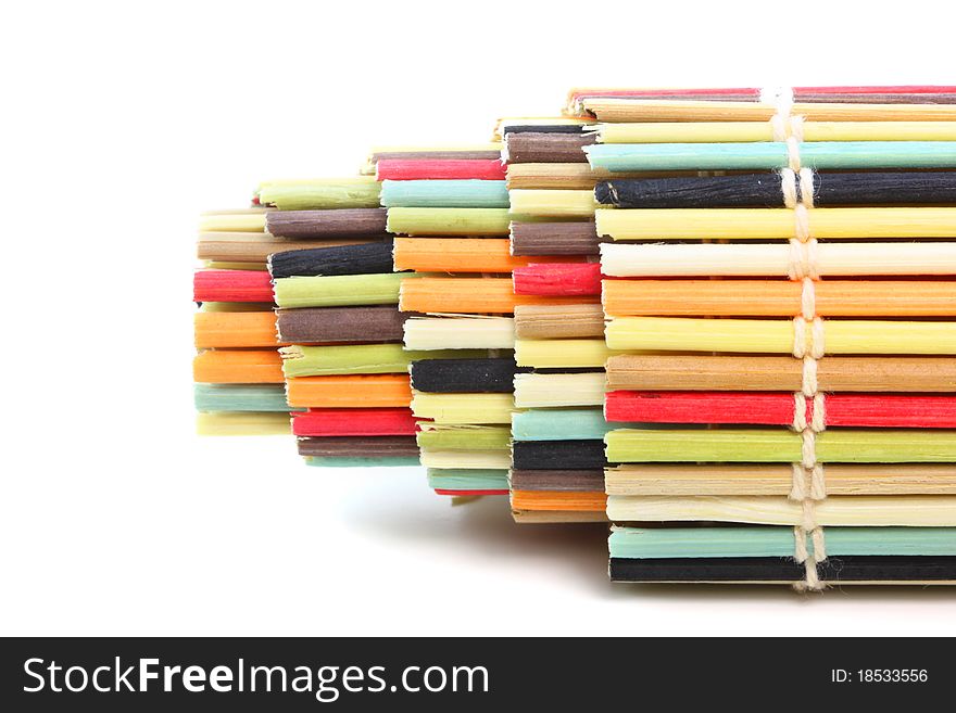 Rolled colorful mat with bamboo isolated on white background