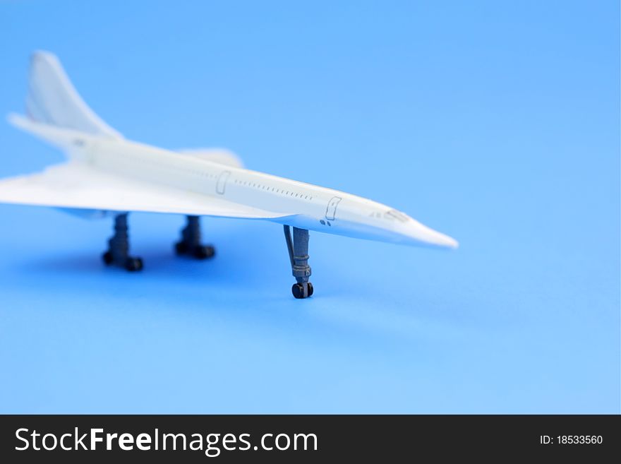 Toy airplane on plain blue background. Toy airplane on plain blue background