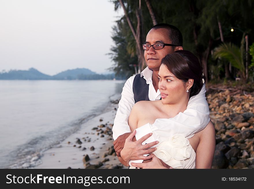 Happy Asian Wedding Couple In Tropical Location