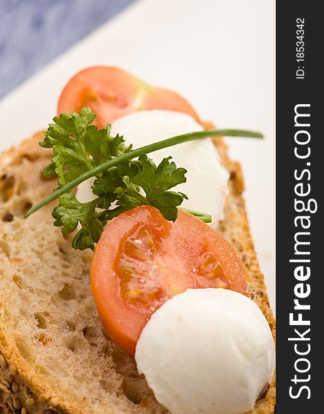 Delicious slice of bread with tomatoe and mozzarella and parsley. Delicious slice of bread with tomatoe and mozzarella and parsley