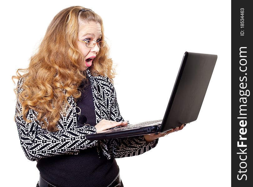 Portrait of a surprised young woman with laptop against white background