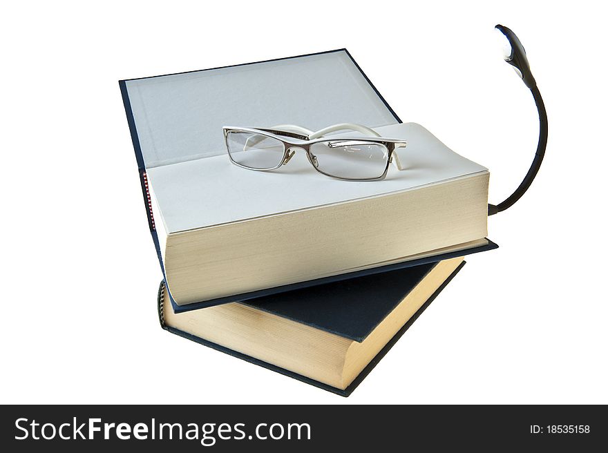 Two books, glasses and flashlight on white background