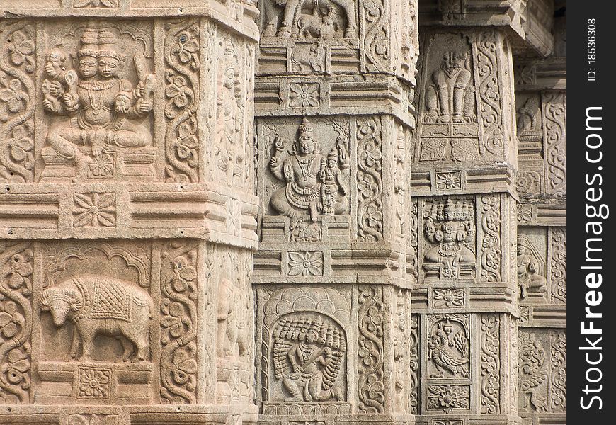 A row of intricately carved columns at a temple entrance. A row of intricately carved columns at a temple entrance